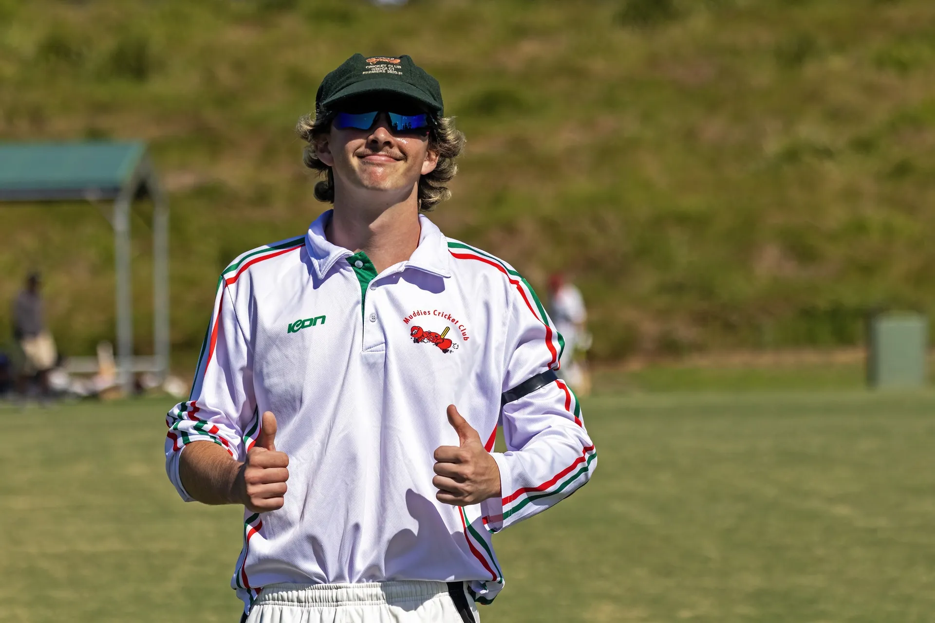 Muddies player in club polo giving two thumbs up after a win